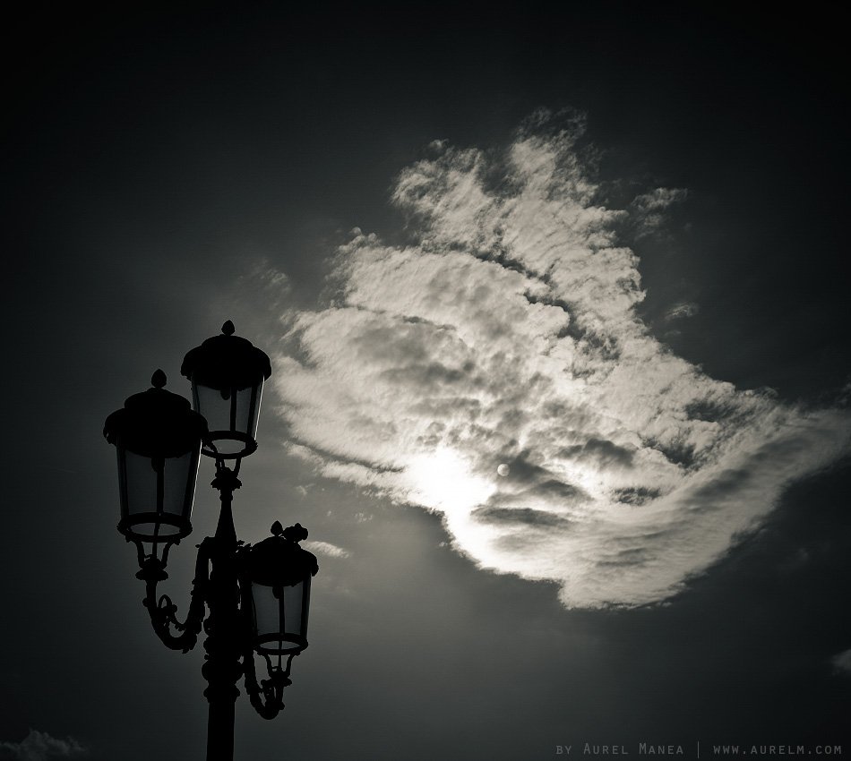 street lamp with cloud and sun