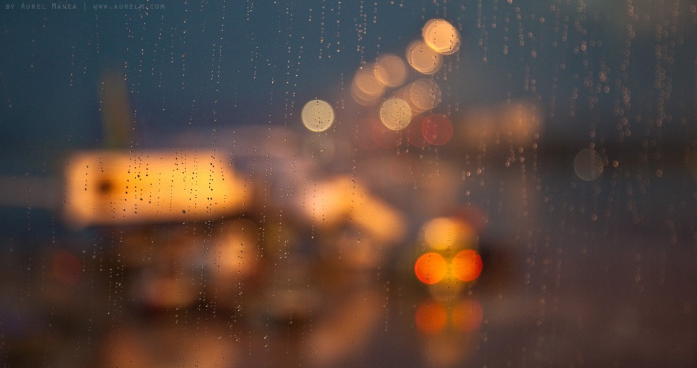 through the rainy window of an airport