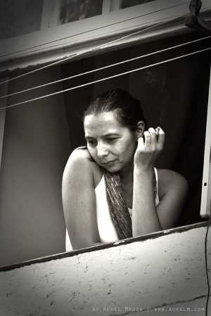 woman smoking on a window in Lisbon