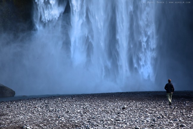man near Skogar waterfall